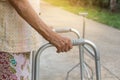 TheÃ¢â¬â¹ Asian old woman standing with his hands on a walking stick,Hand of old woman holding a staff cane Royalty Free Stock Photo